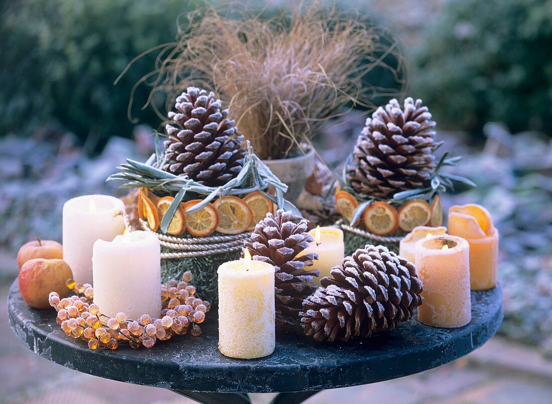Winter decoration with frost: pine cones, apples, orange slices