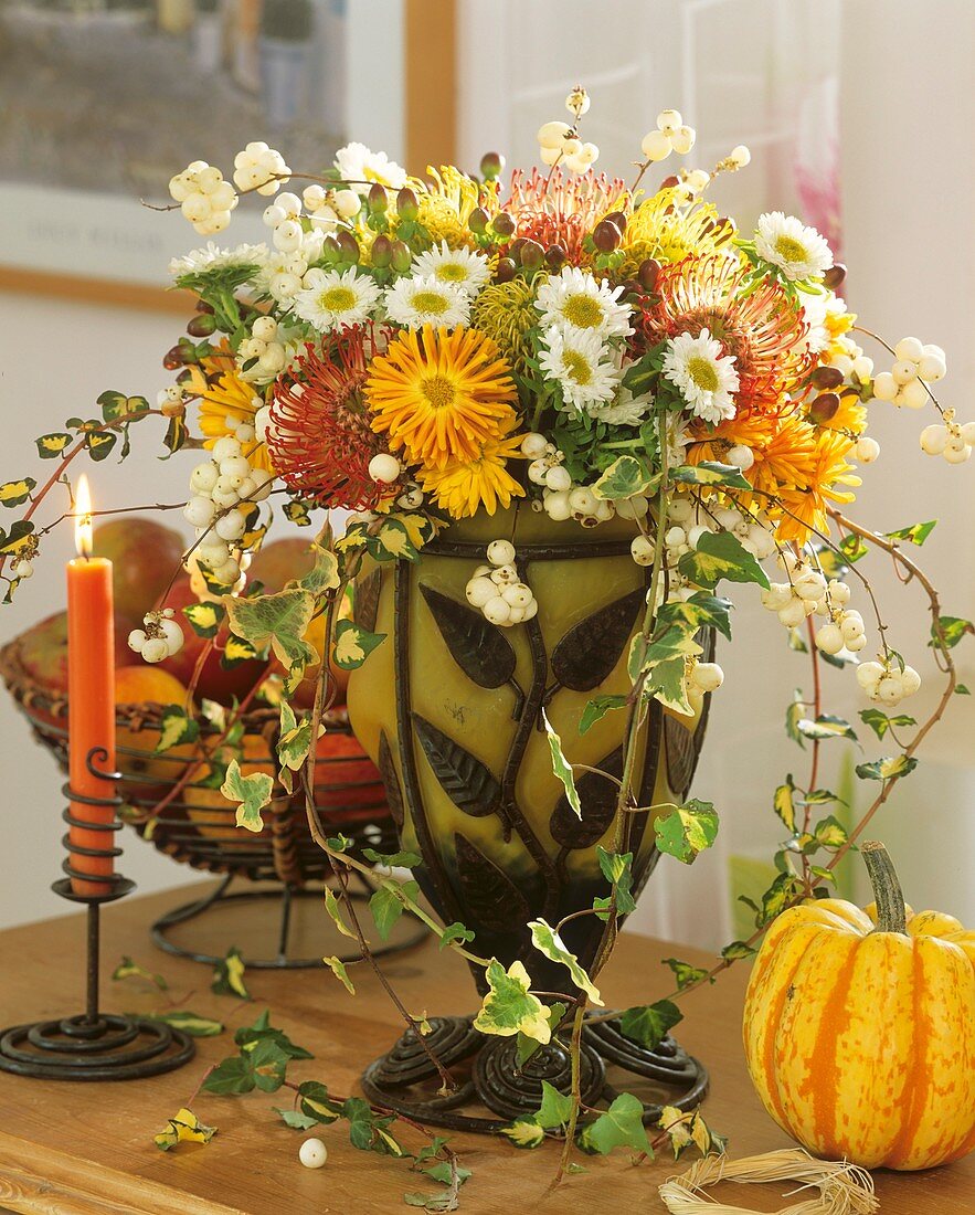 Arrangement of chrysanthemums, Protea flowers and snowberries