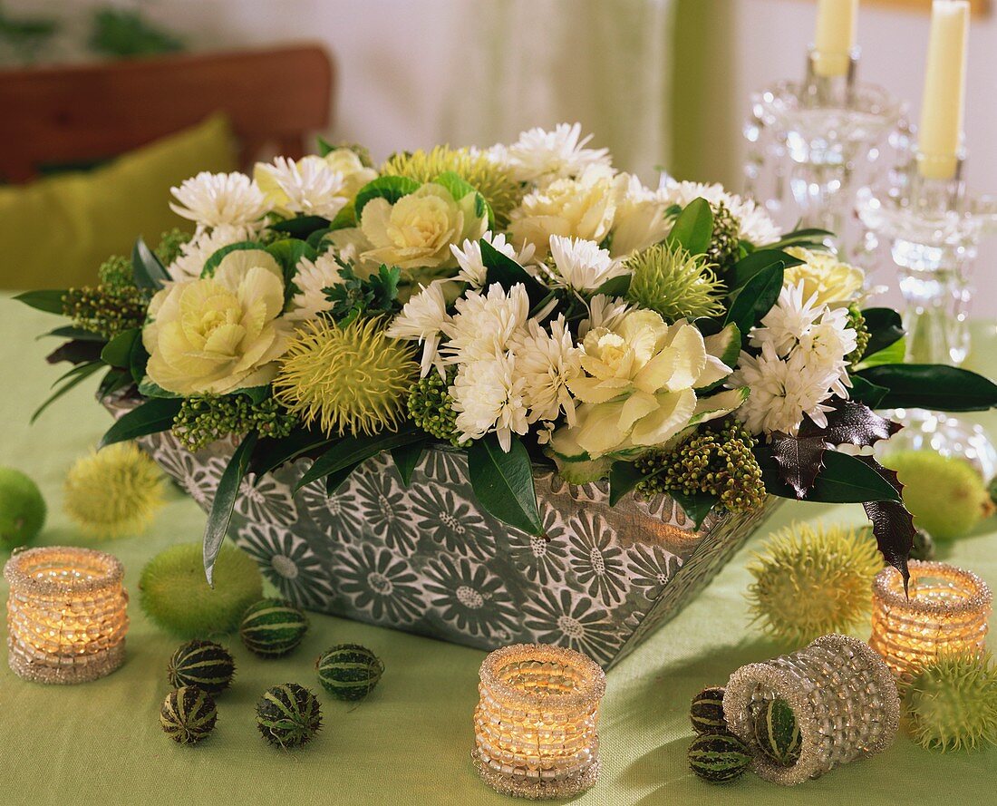 Arrangement of ornamental cabbage, chrysanthemums & tropical fruits