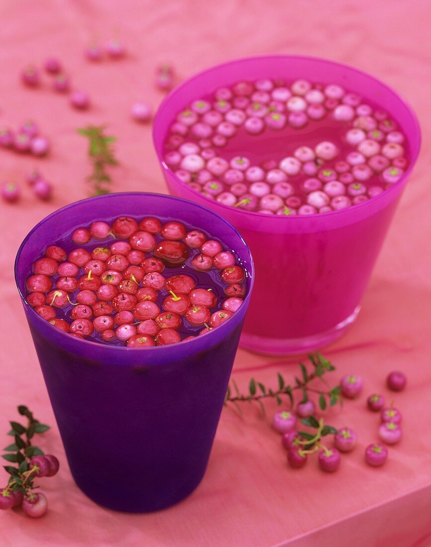 Pernettya berries floating in pink and purple glasses