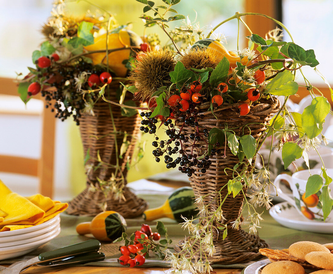 Table arrangements of ornamental gourds, Clematis & rose hips