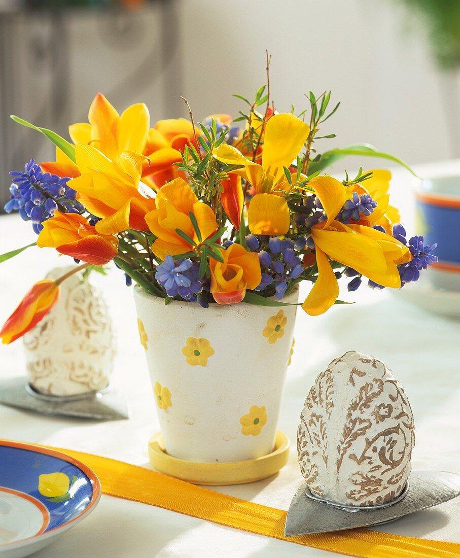 Easter eggs and arrangement of tulips and grape hyacinths