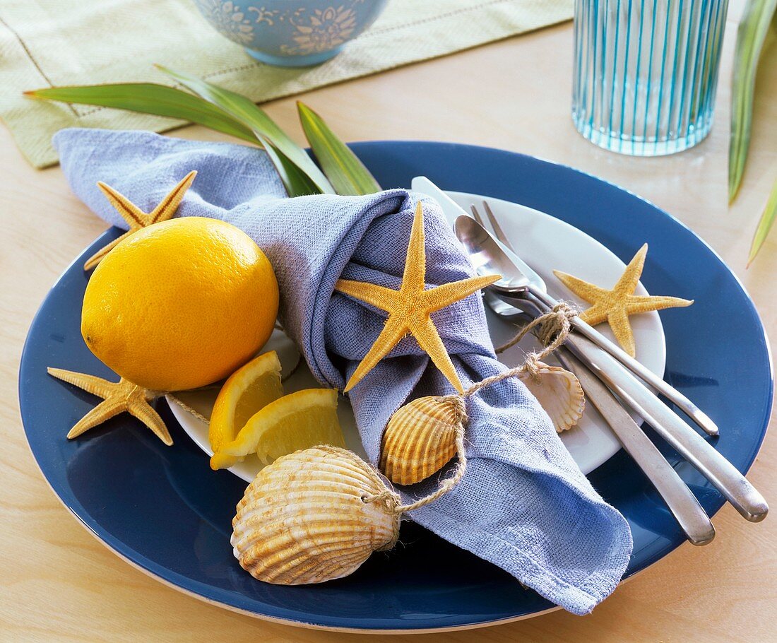 Place-setting decorated with orange, starfish and sea shells