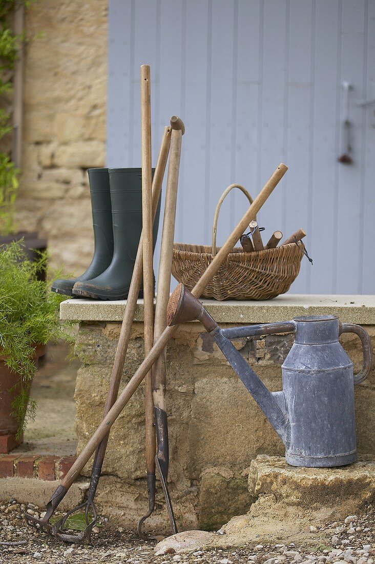 Various garden tools, watering can and rubber boots