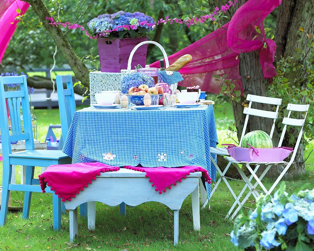 Table laid for picnic in garden