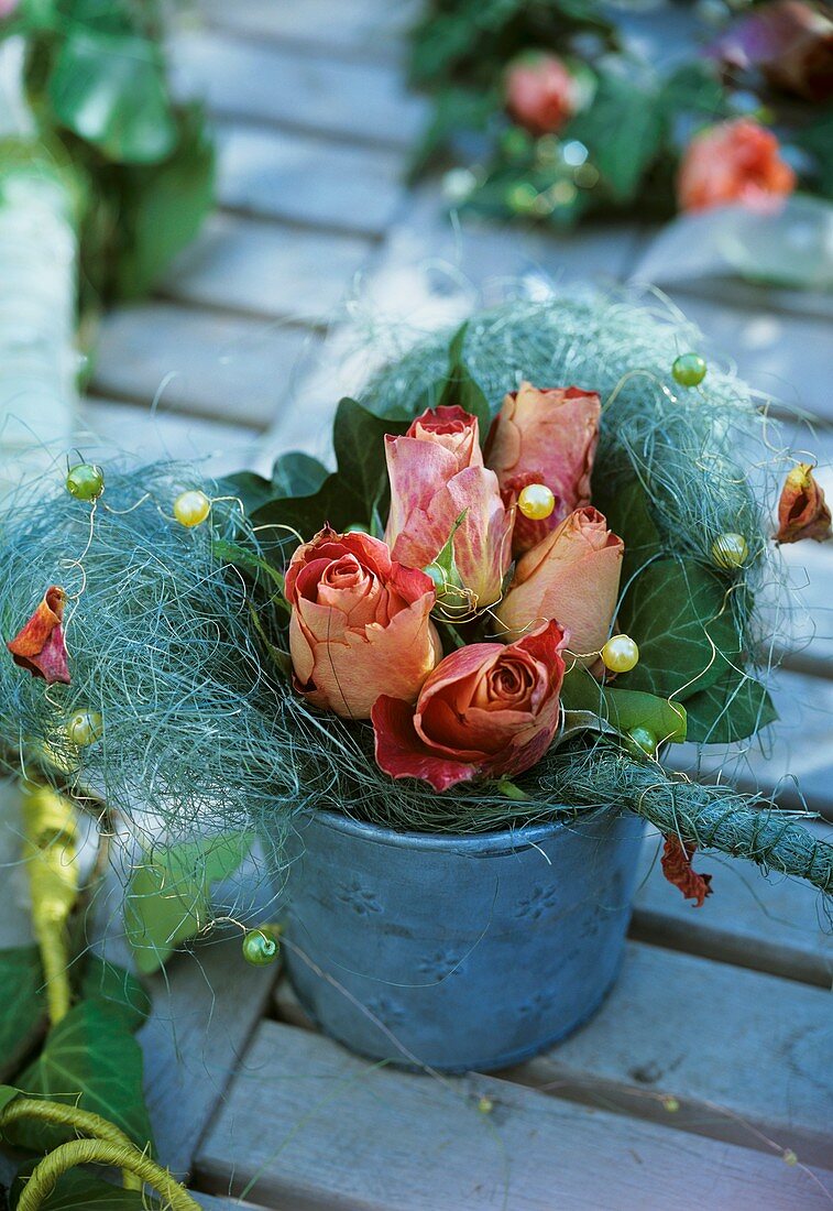 Metal vase with sisal heart, roses and ivy