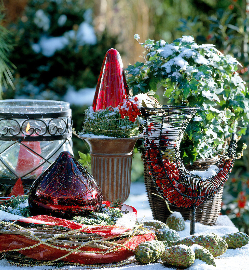 Christmas decoration: windlight, baubles, ivy