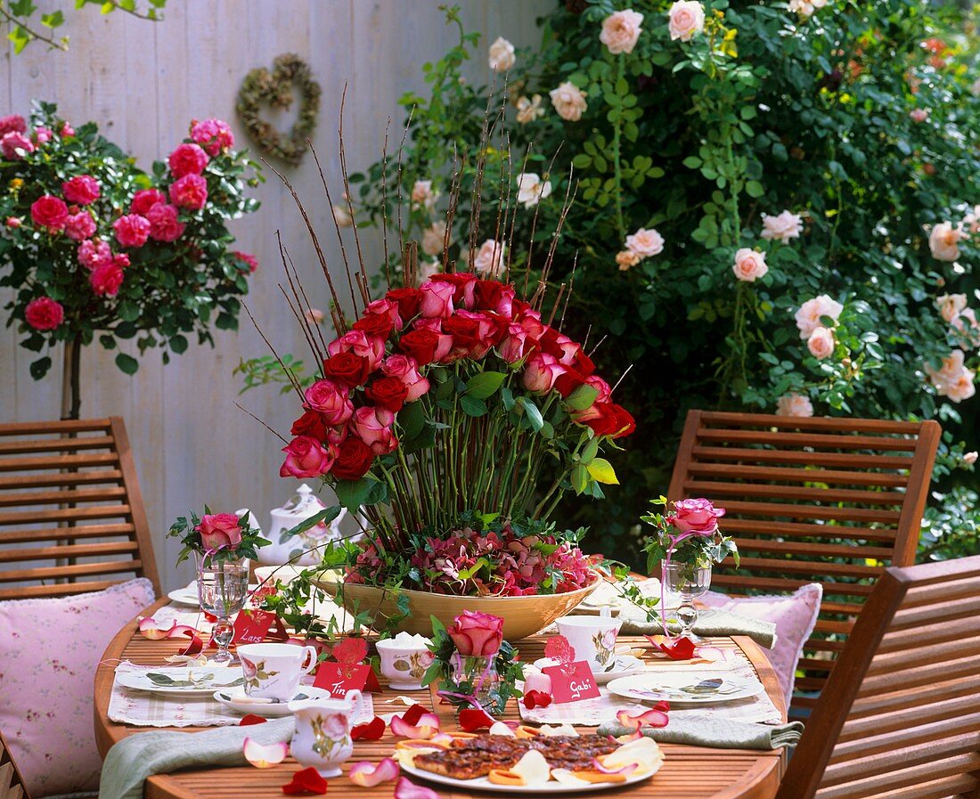 Festive table with roses in open air