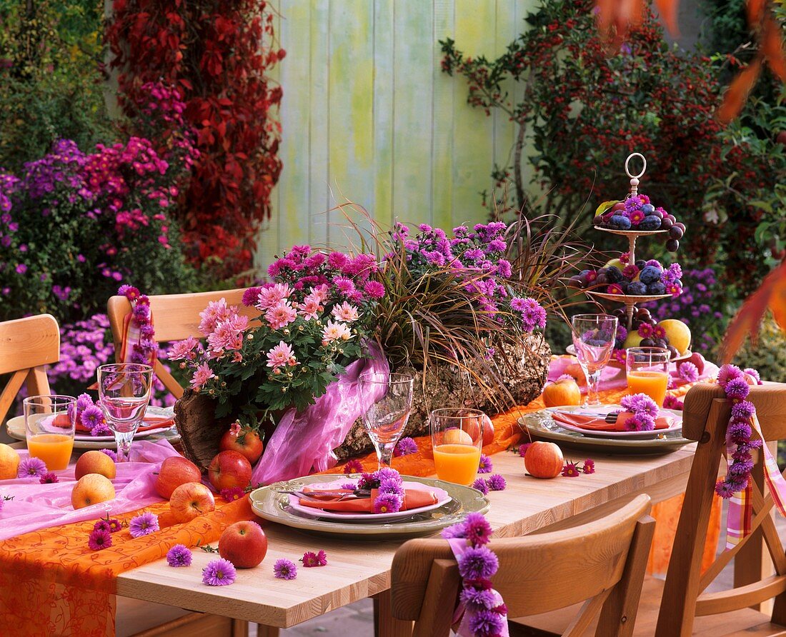 Laid table with flower garlands and apples