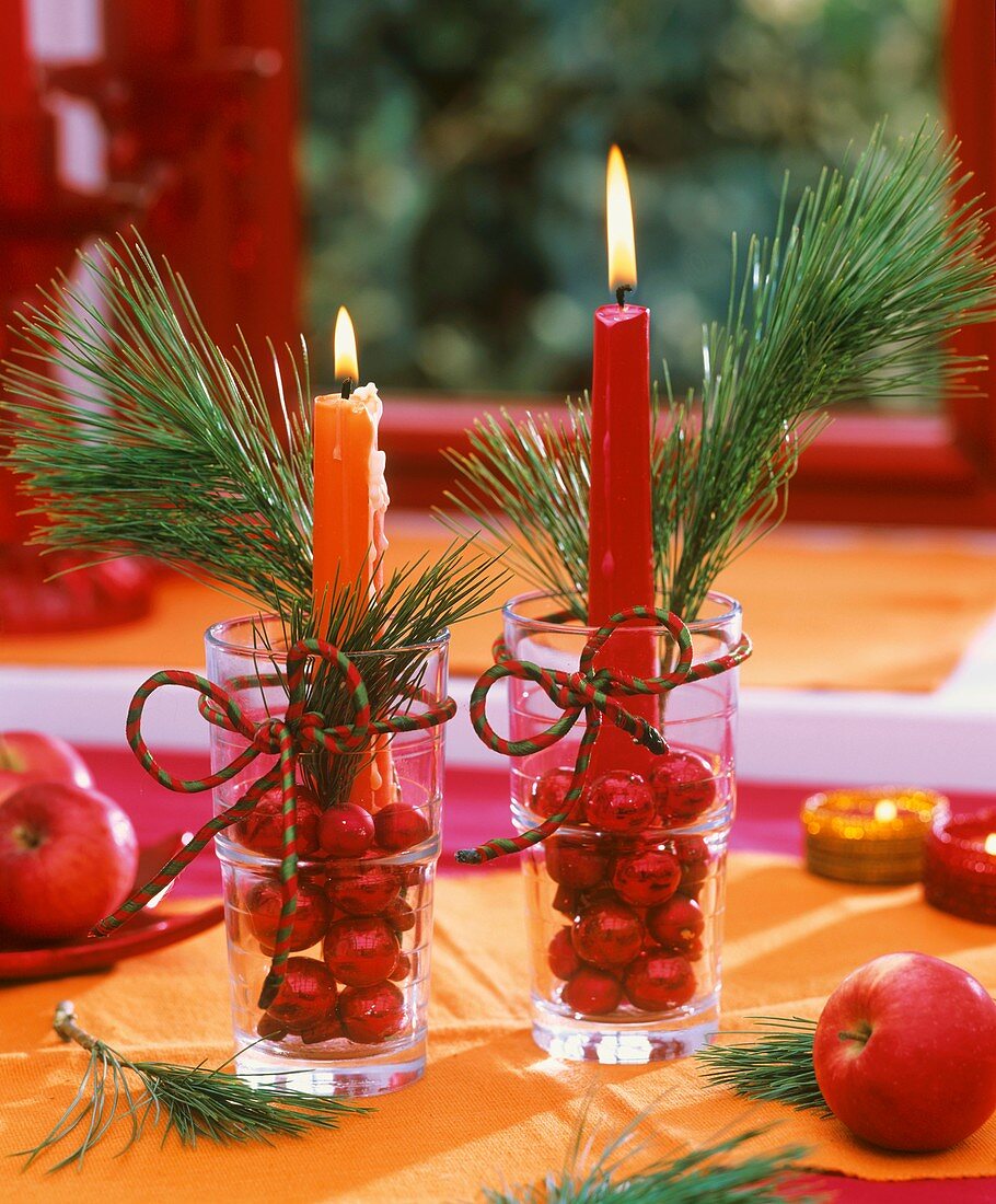 Arrangement with candles, pine sprigs & Christmas baubles