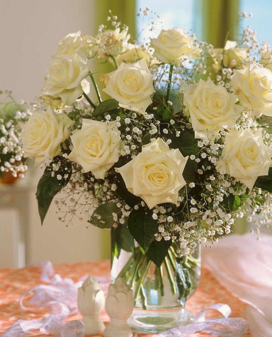 Vase of white roses and gypsophila