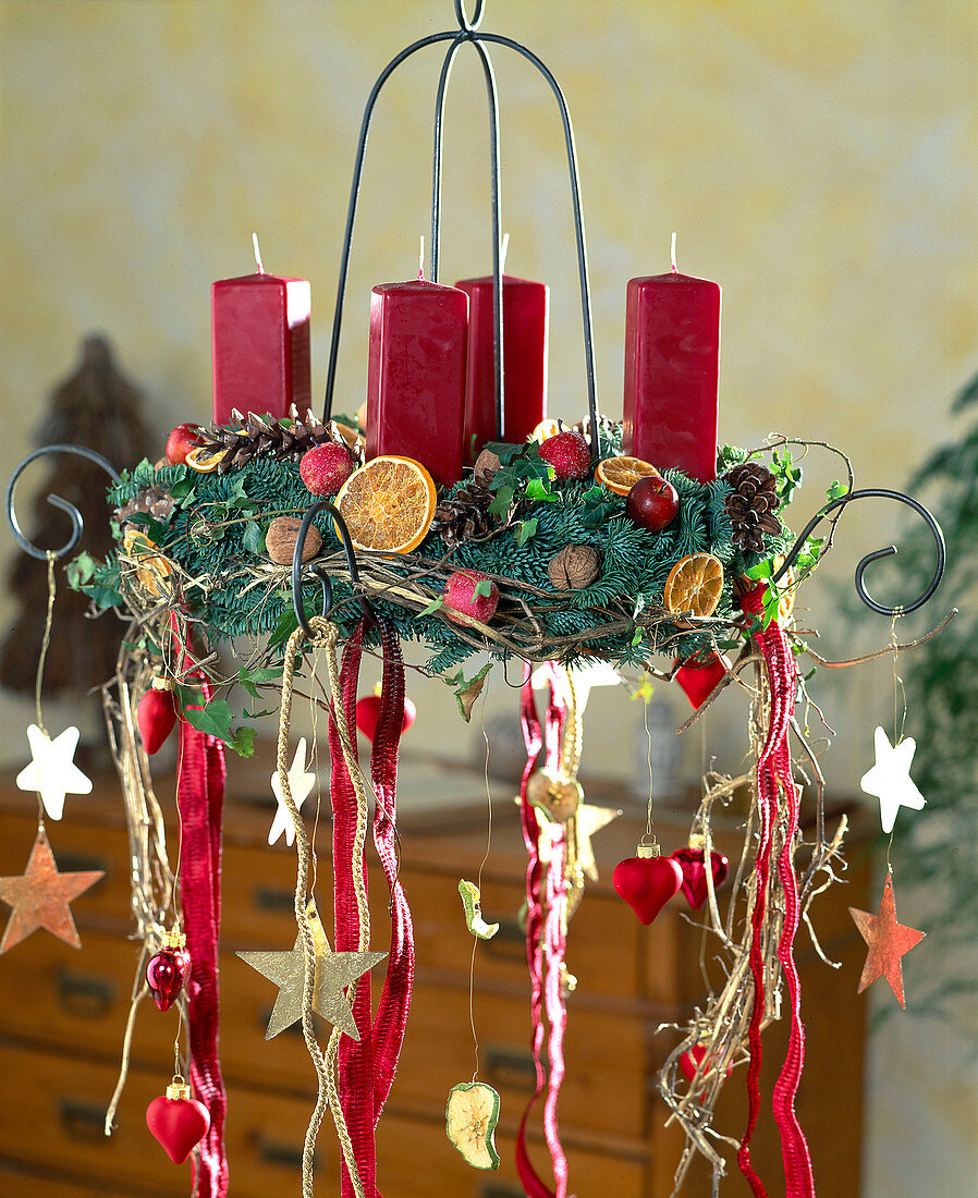 Hanging Advent wreath with red candles and ribbons