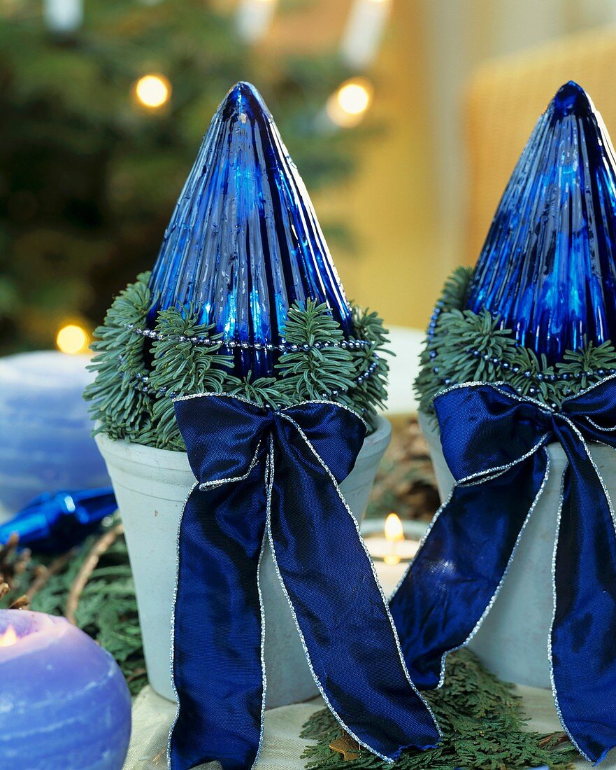 Christmas decoration with glass cones, fir sprigs and bows