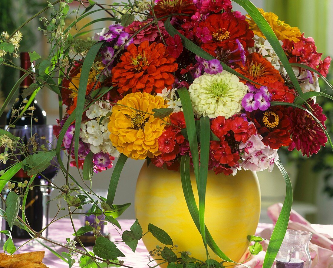 Arrangement of zinnias, Phlox, Chinese silvergrass & Clematis