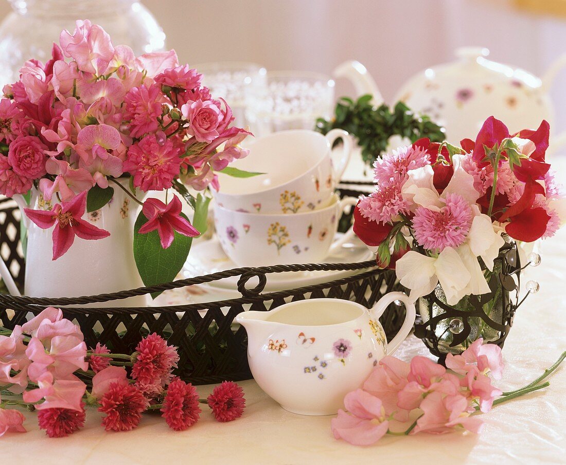 Iron tray with tea things and fragrant posy