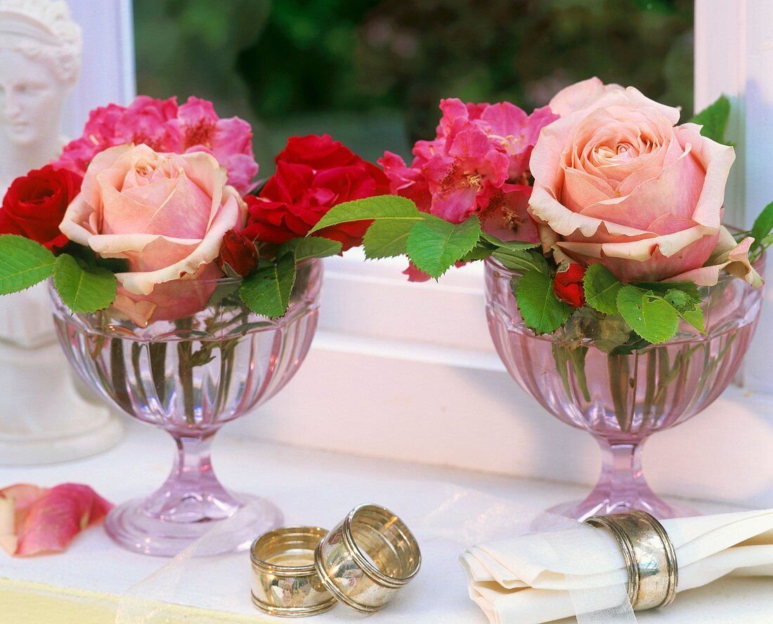Roses and rhododendrons in glass goblets