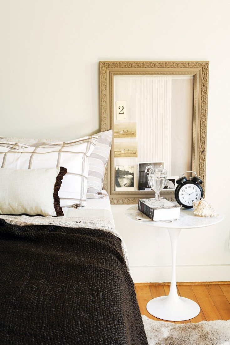 Bedside table and picture frame beside bed