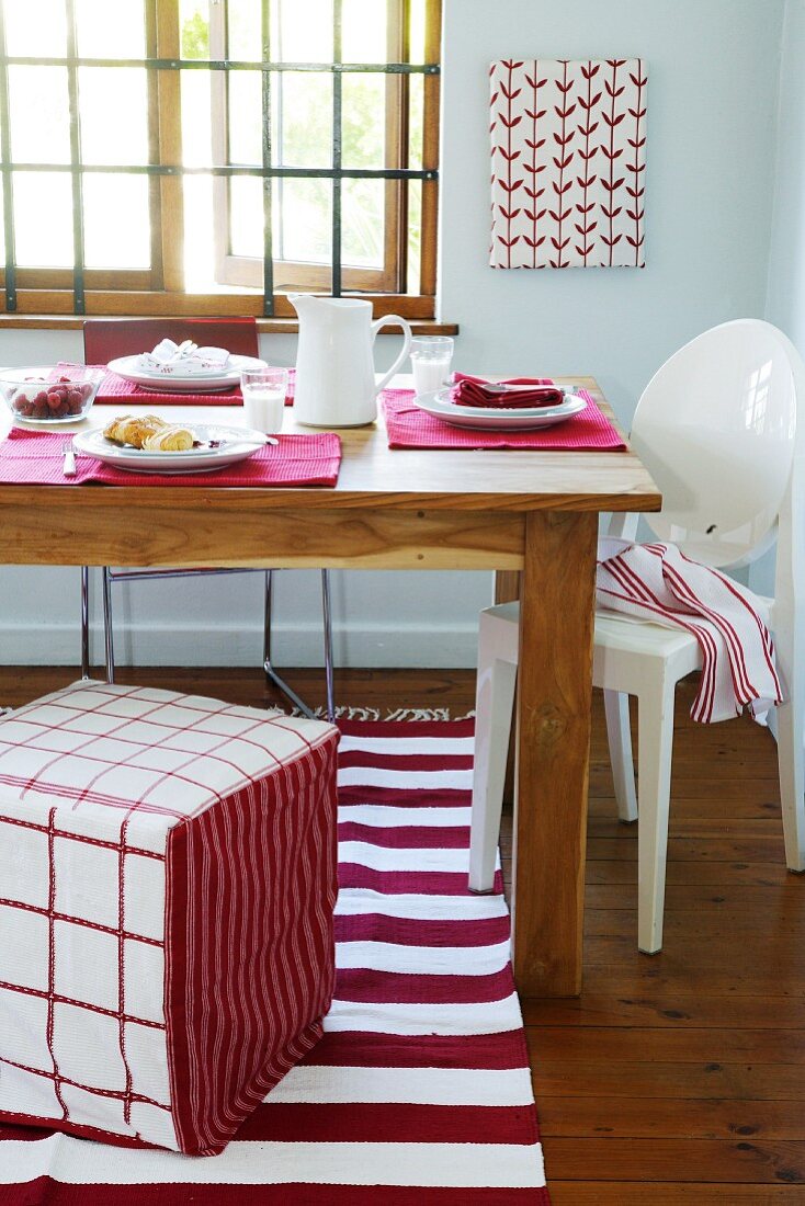 A dining table laid in red and white