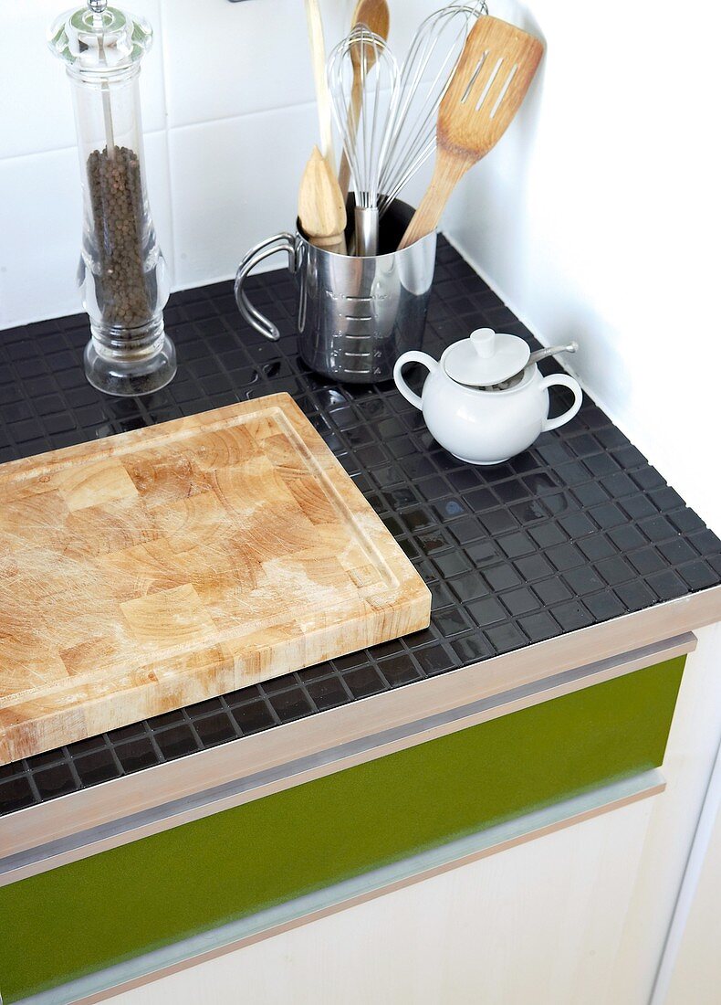 A kitchen work top with mosaic tiles