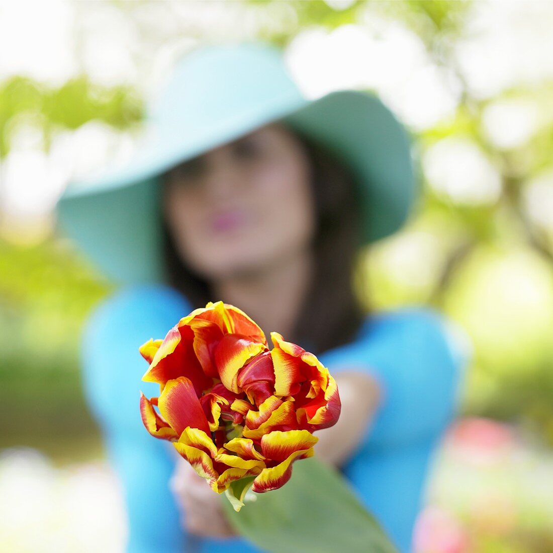 Frau mit Tulpe im Garten