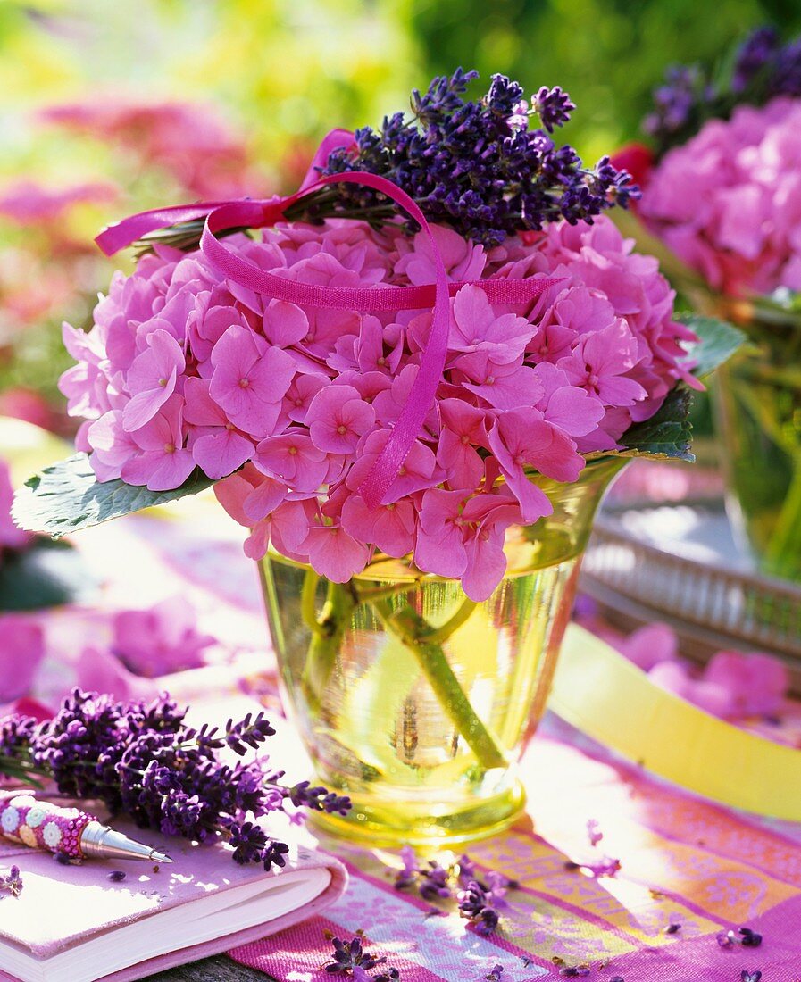 Pink hydrangeas with bunch of lavender in glass vase