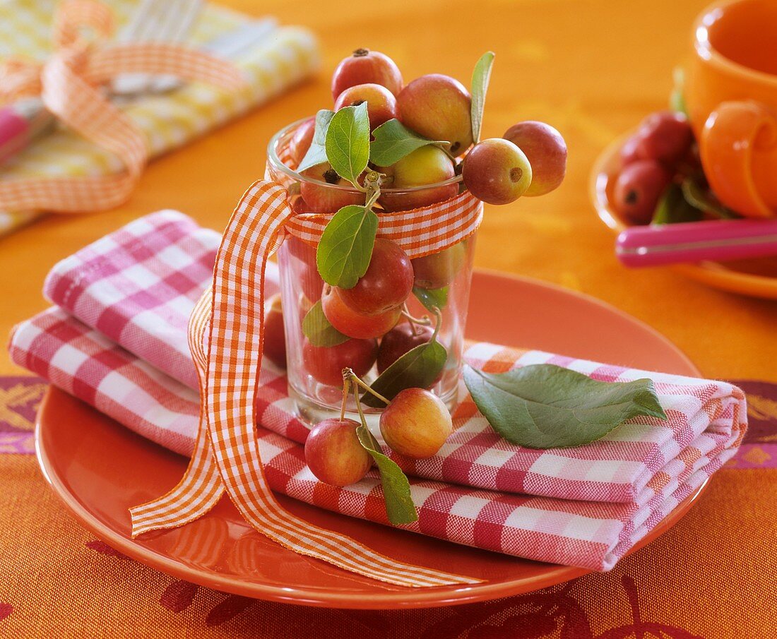 Crab apples in jar on checked napkin