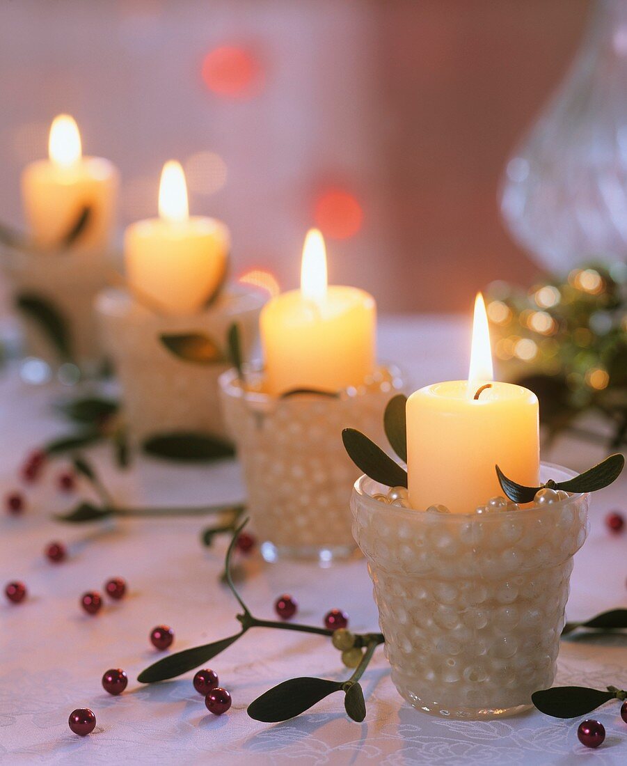 Four Advent candles (White pillar candles with mistletoe, beads)