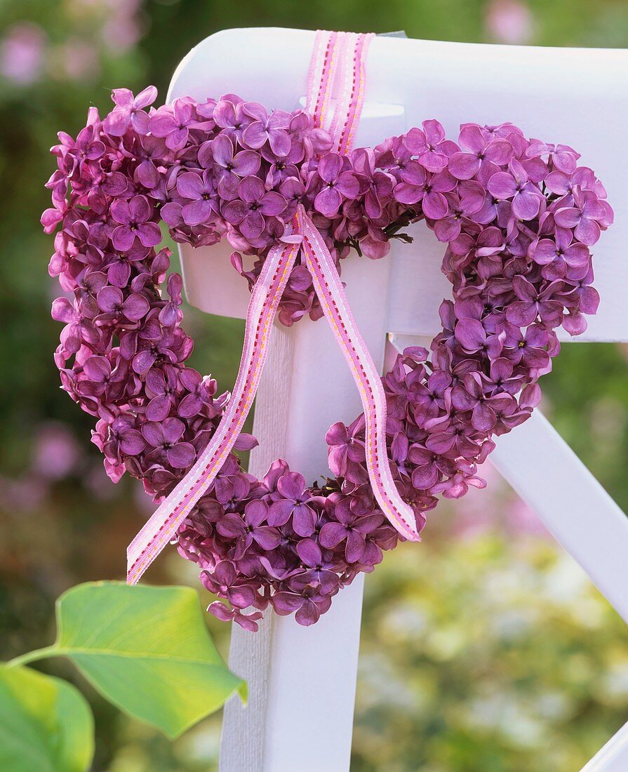 Heart-shaped lilac wreath tied to chair back