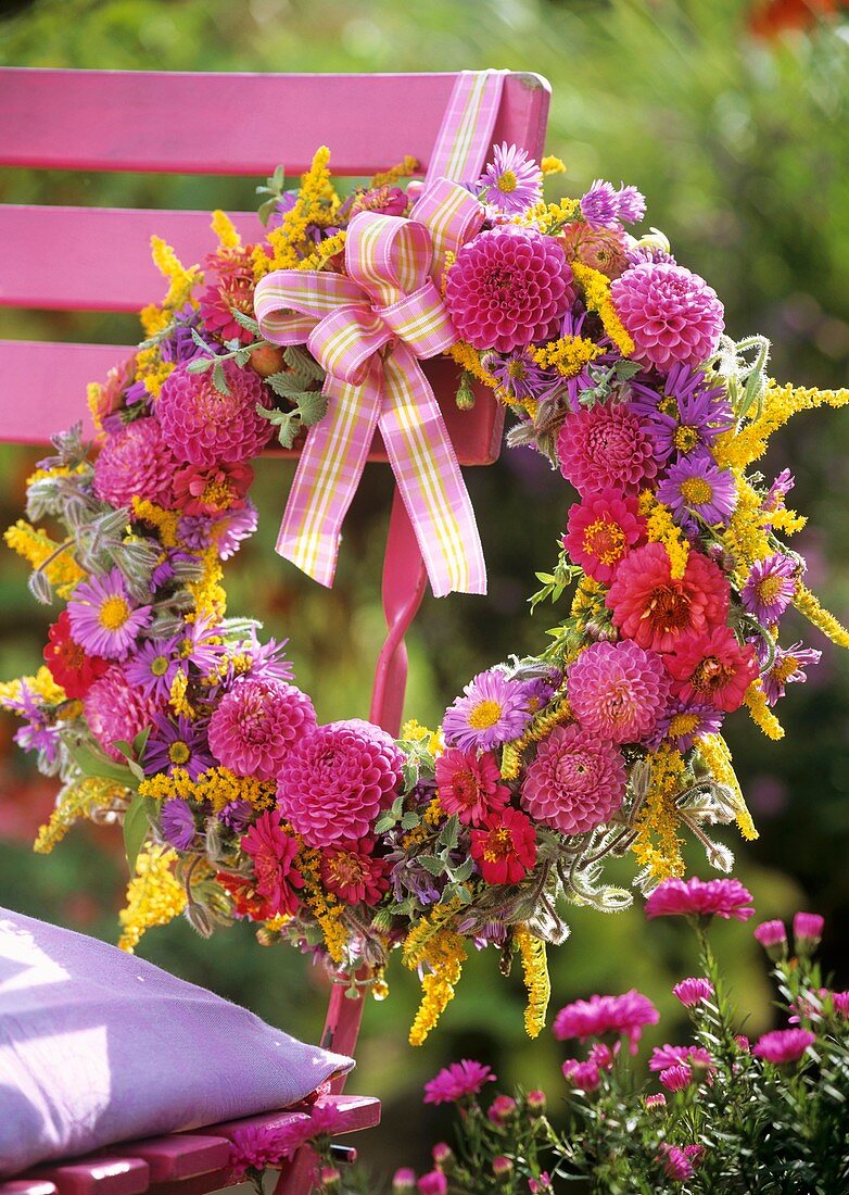 Wreath of dahlias hanging on a chair back