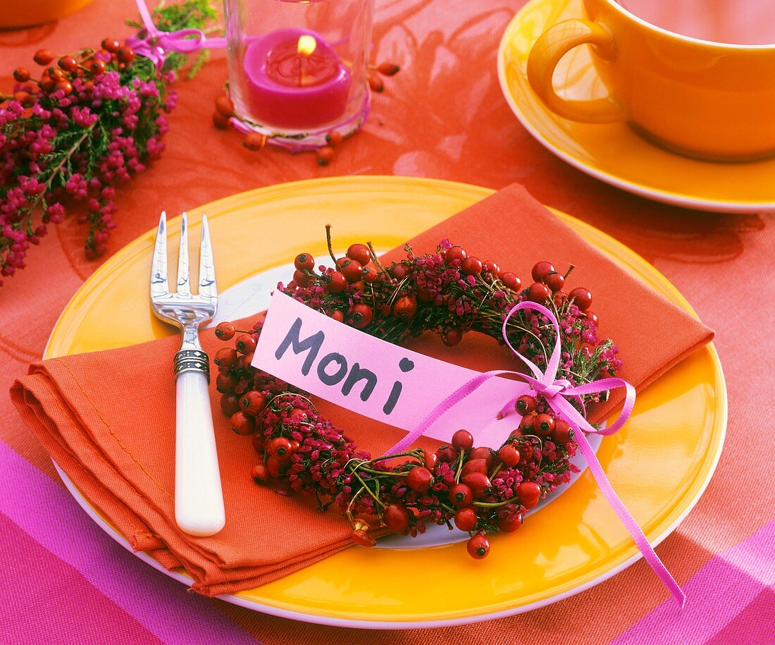 Place-setting with rose hip wreath and place card
