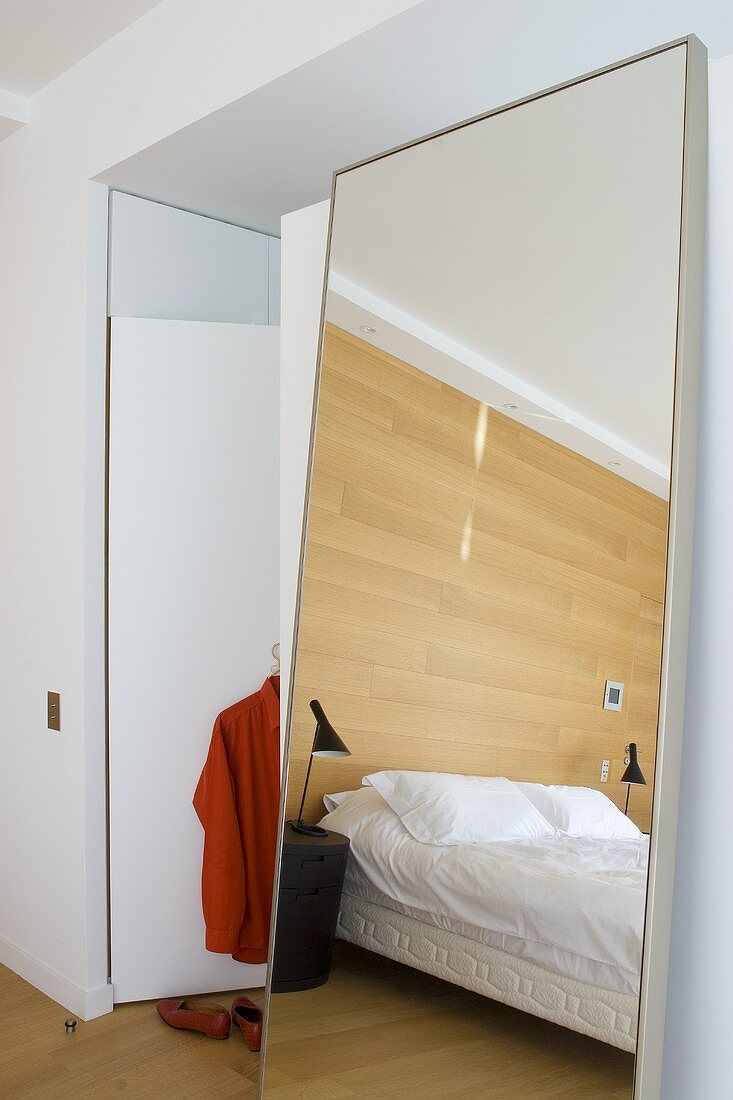 Bedroom with mirror in architect-designed house