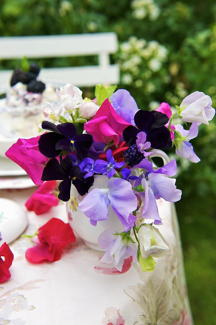 Romantic vase of flowers on garden table