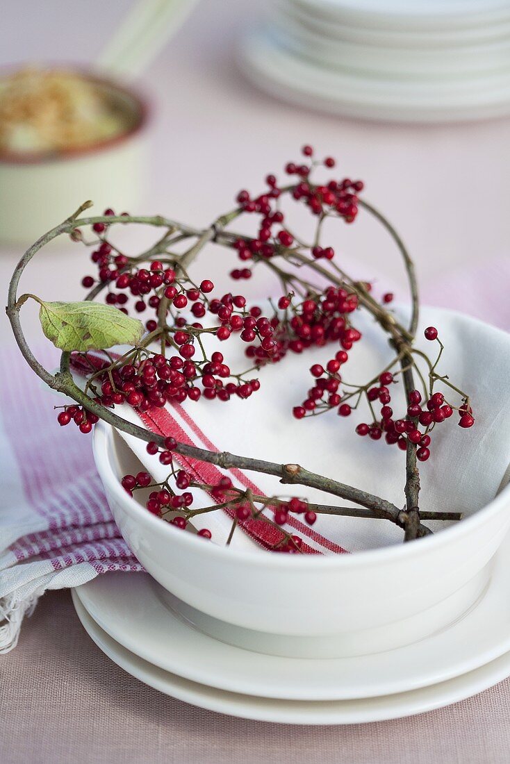 Place-setting with a heart of viburnum twigs and berries
