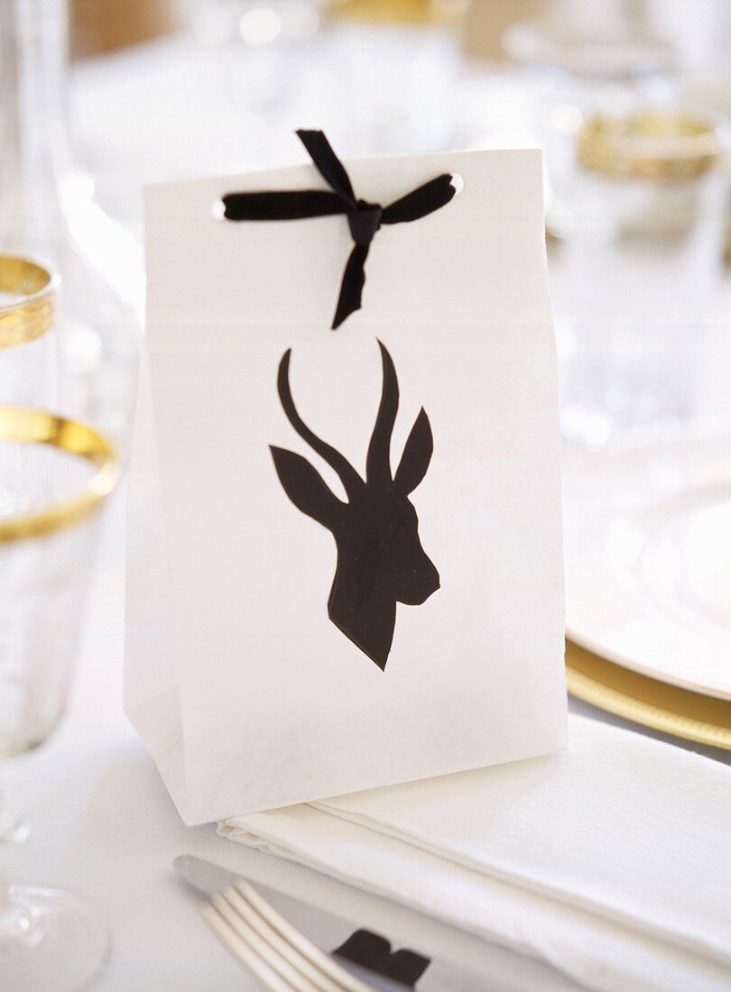Paper bag with animal silhouette used as place card