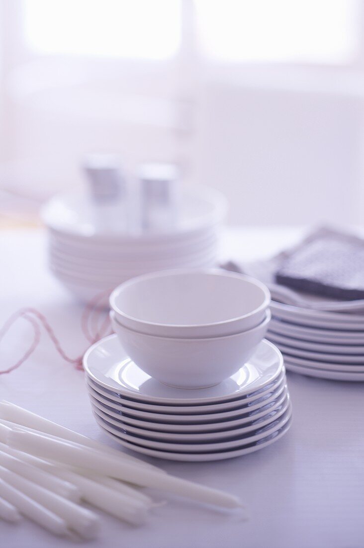 White crockery and candles on a table