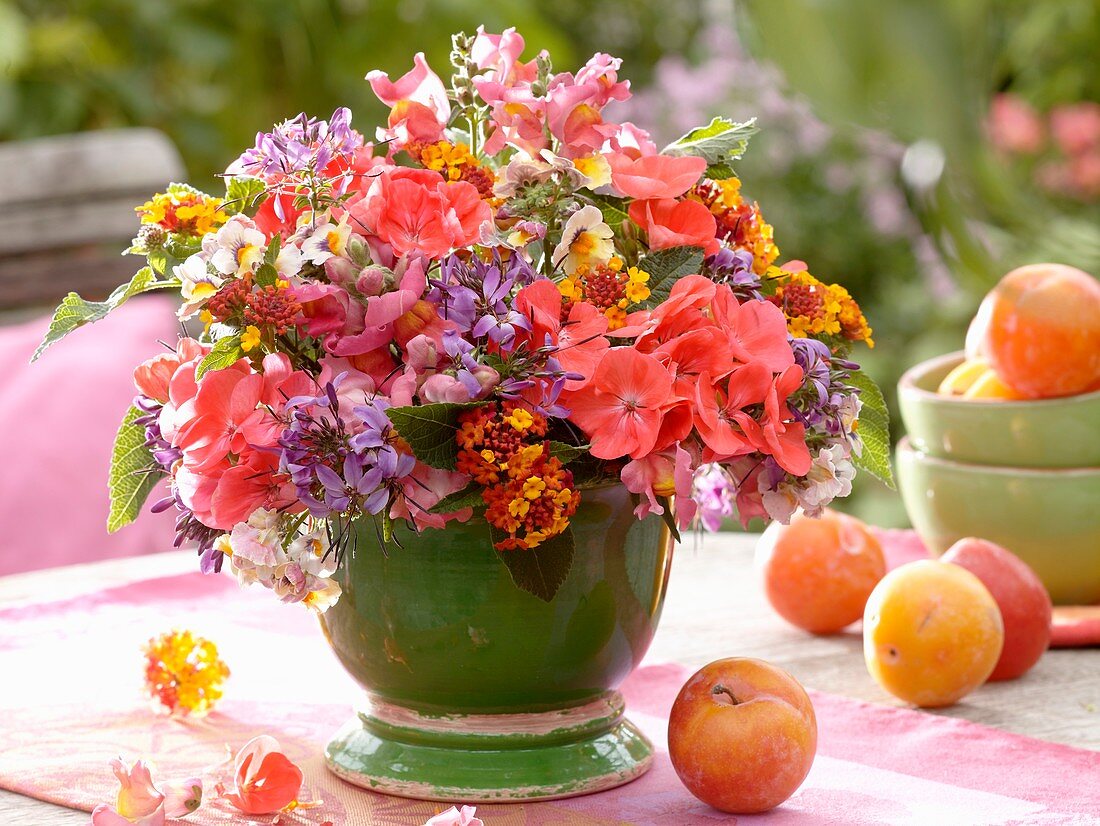 Arrangement of late summer flowers on garden table