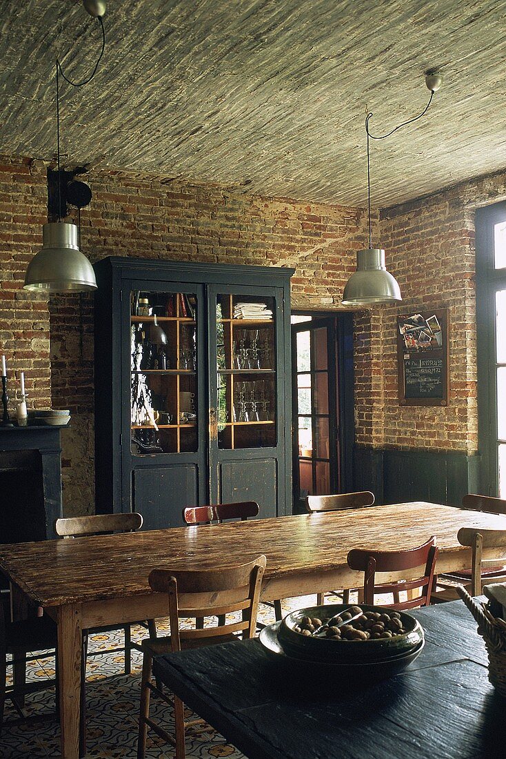 Rustic dining room with brick walls and large wooden table