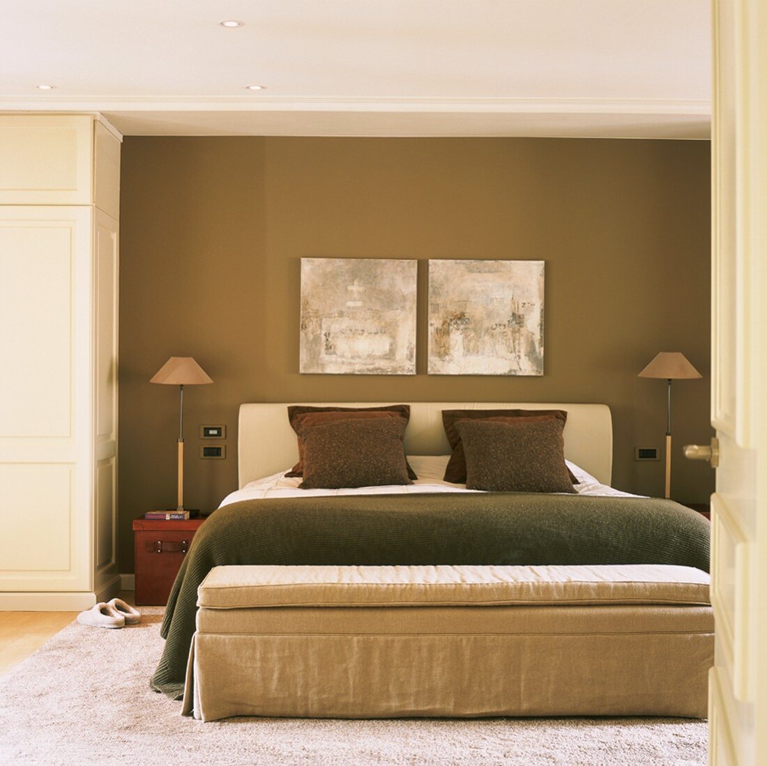 Bedroom in natural shades with double bed and upholstered bench