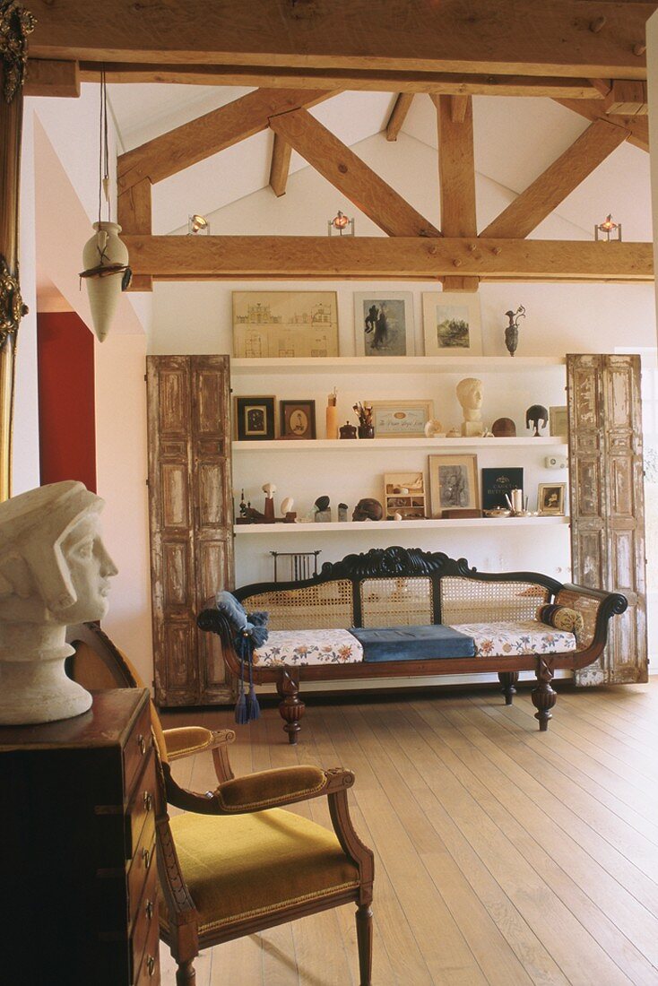 Interior with exposed roof structure and antique bench