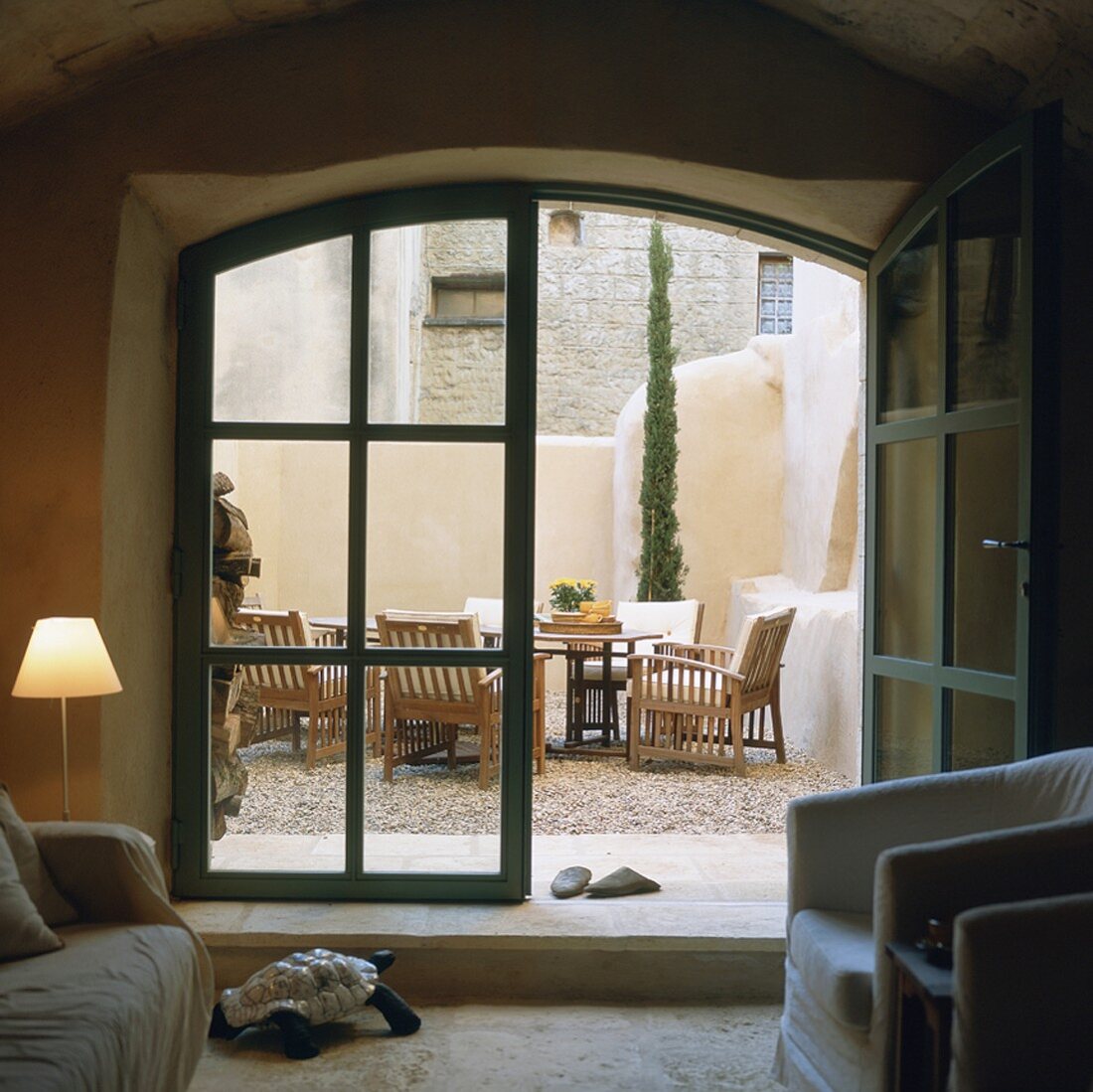 Interior with view of terrace and garden wall