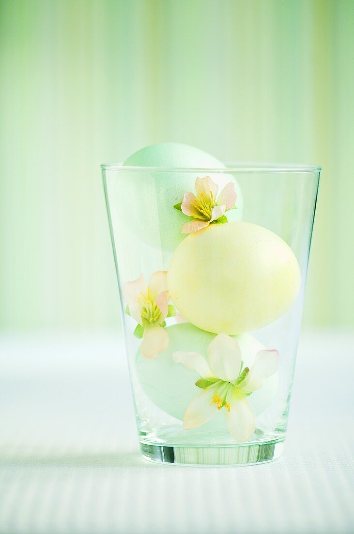 Easter eggs and flowers in glass