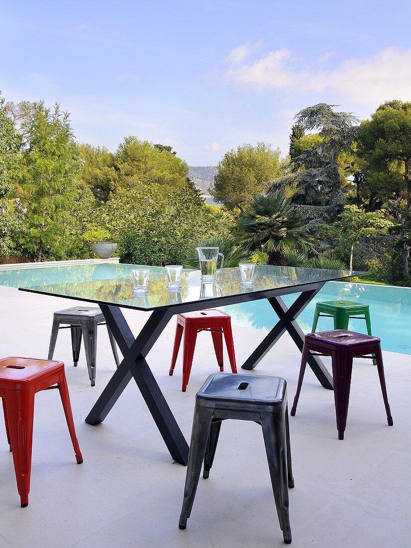Designer table and stools by swimming pool