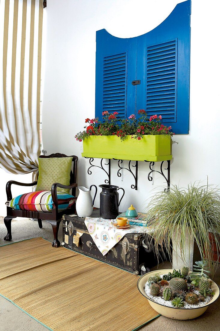 Blue shutters with furniture in front