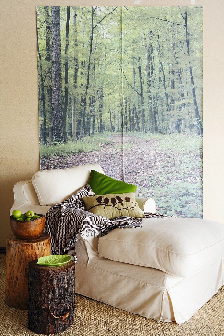 A sofa in front of a wall poster