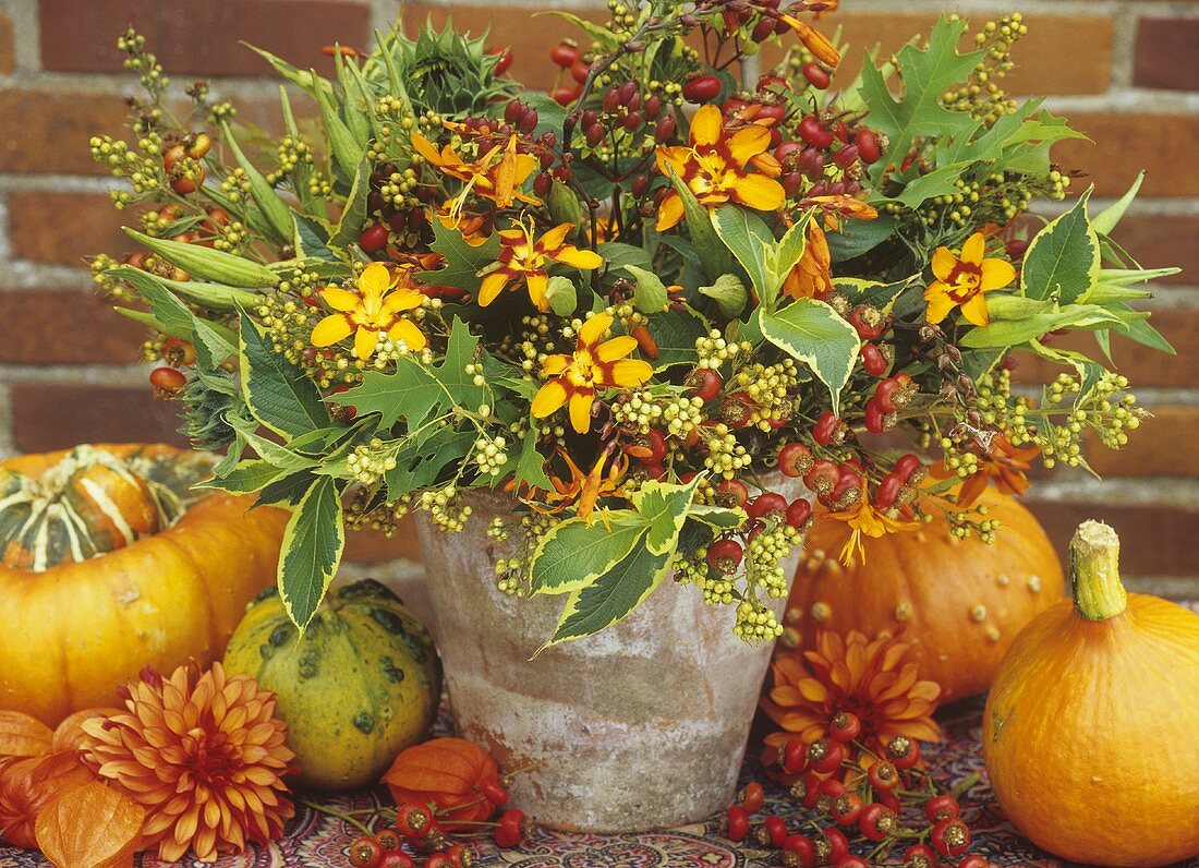 Autumnal arrangement of montbretia, rose hips and dogwood