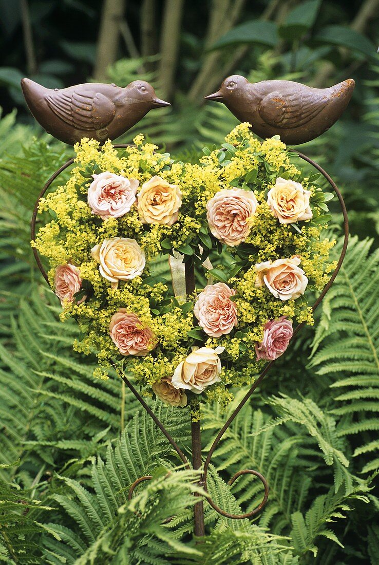 Heart-shaped arrangement of roses in garden