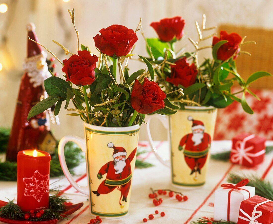 Roses in beakers with Father Christmas motifs