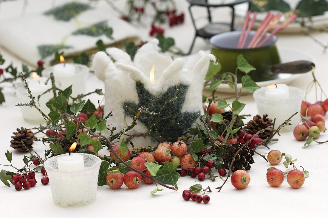 Wintry table decoration with candles and felt