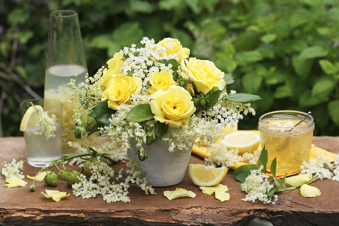 Vase of yellow roses and elderflowers