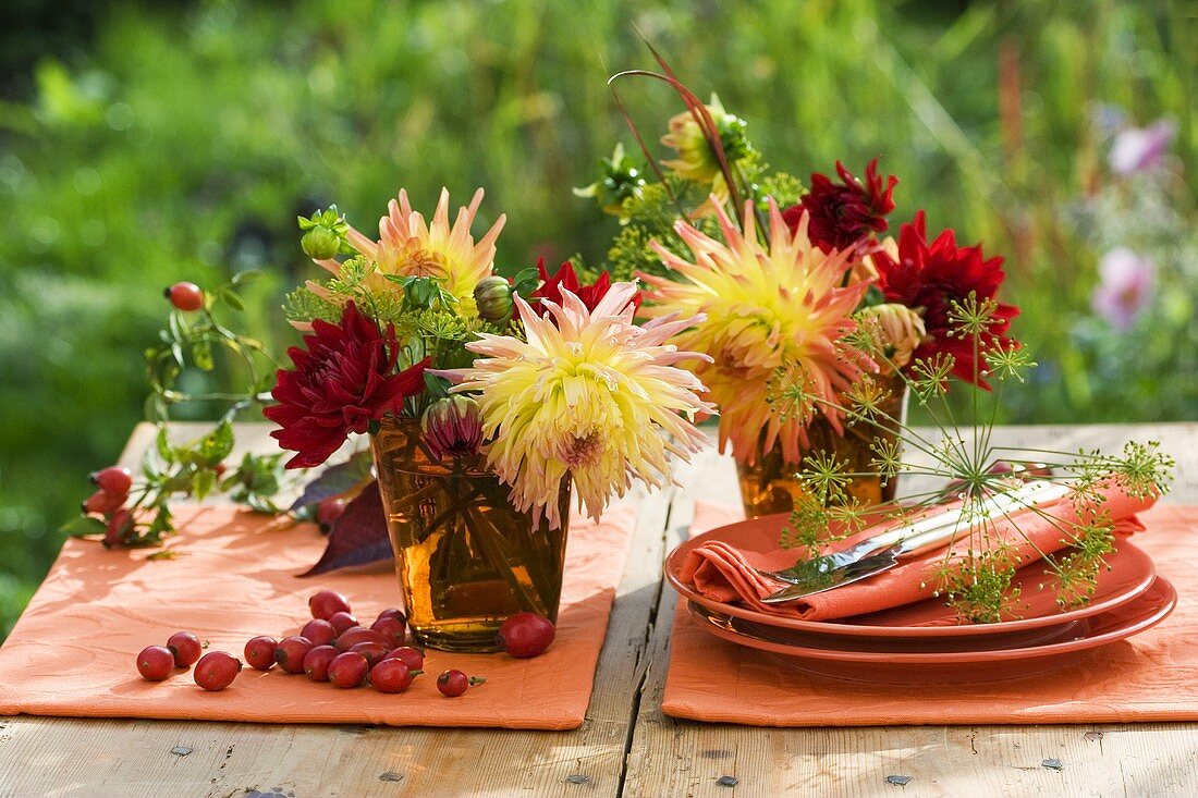 Autumn table decoration of dahlias and rose hips